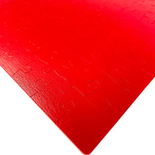 Load image into Gallery viewer, corner detail of 2-sided monochrome fire engine red puzzle
